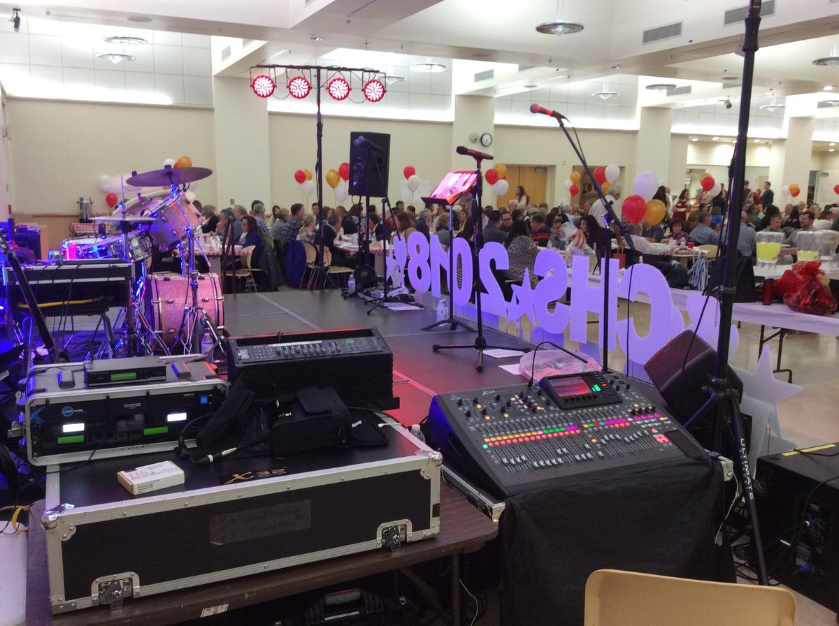 Mixing console and stage lights set up at a banquet hall event